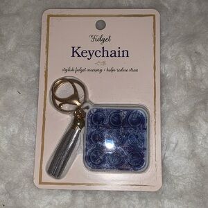 Keychain stylish fidget accessory, helps reduce stress.